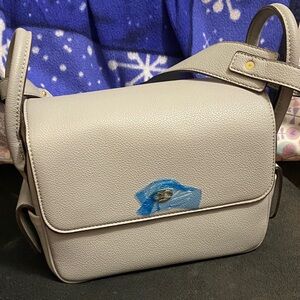 Pebbled Cream Crossbody Bag with Flap Closure